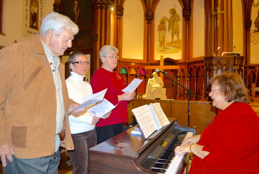 Marlene Bailey, right, of St. Joseph’s Catholic Church in North Sydney plays the piano as, left, Joe Burton, Betty Nicholas-Foster and Irish Young rehearse in preparation for the annual Northside Festival of Choirs. The event takes place Sunday at St. Joseph’s.