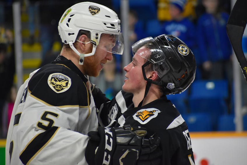 An emotional Hunter Drew of the Charlottetown Islanders, left, shakes hands with former teammate Derek Gentile of the Cape Breton Screaming Eagles following Game 6 of their Quebec Major Junior Hockey League opening round series Sunday at Centre 200 in Sydney. The Screaming Eagles won the series with a 4-3 overtime victory.