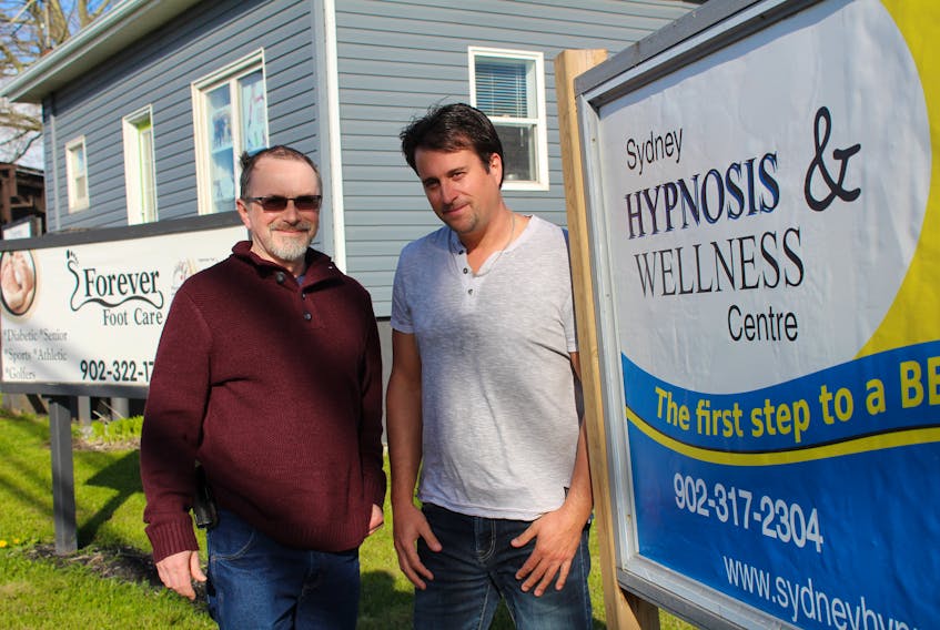 Glenn MacDonald, left, and Carmen Giorno stand outside their Sydney Hypnosis and Wellness Centre located at 250 Welton St. in Sydney. The two are trained hypnotherapists who have been helping clients for about a year and a half.