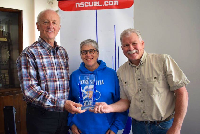 Proudly receiving the 2019 Organization of the Year award on behalf of the Chedabucto Curling Club, from Nova Scotia Curling Association president Cathy Dalziel, is club president Ray Bates and vice-president Maurice Landry. Virginia Jackson