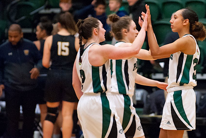UPEI Panthers guard, from left, Reese Baxendale, Annabelle Charron and Lauren Rainford celebrate a play Friday against the Dalhousie Tigers in Atlantic University Sport women’s basketball action.