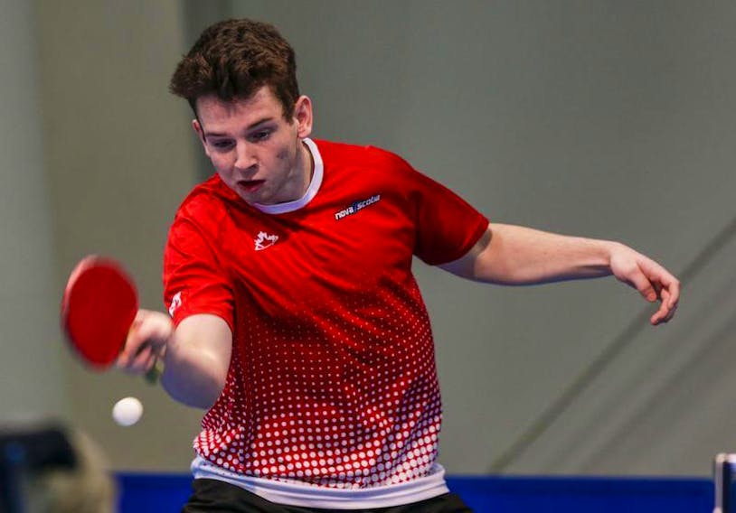 Dartmouth’s Liam Caron competes in table tennis action at the Canada Winter Games in Red Deer, Alta., on Monday. Caron won two matches on Monday.