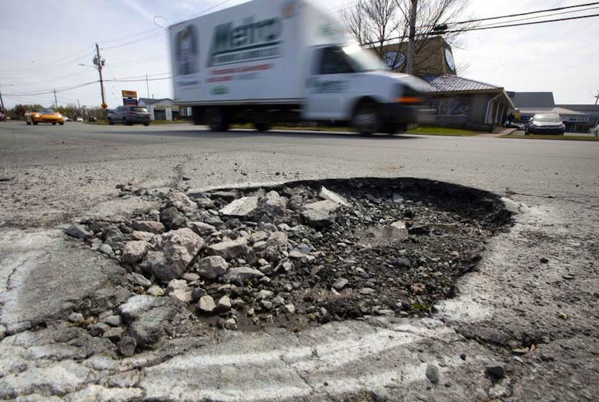 A large pothole remains untouched on Eisener Boulevard in Dartmouth Tuesday. The pothole was spray painted back in March, but city crews have yet to repair the hole in the road.