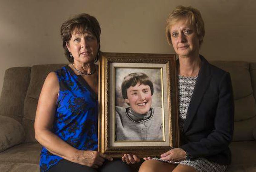 Elizabeth Deveau and Dorothy Dunnington hold a photo of their sister Chrissy who died earlier this year from an infected bedsore. (RYAN TAPLIN / Staff)