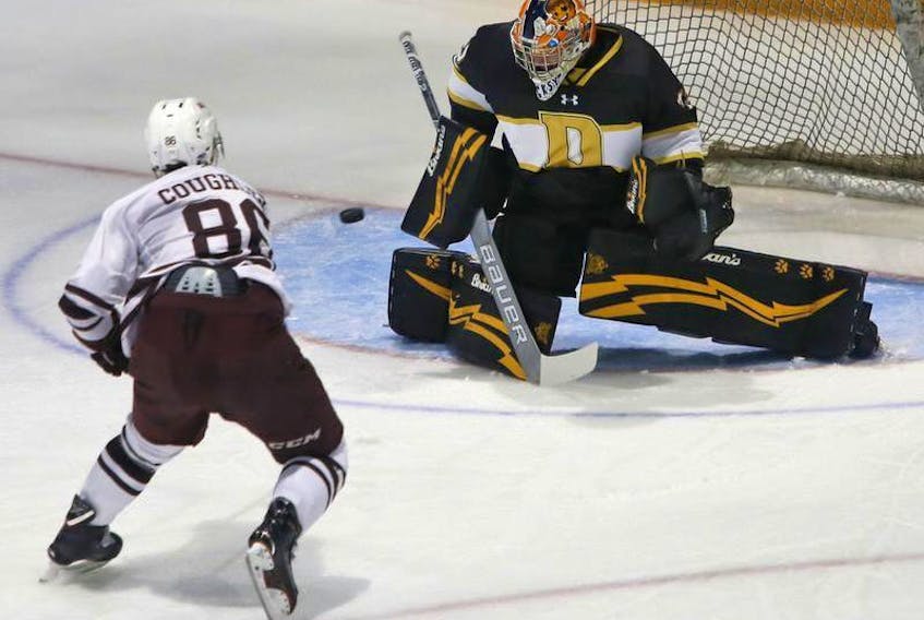 Saint Mary’s Huskies forward Jake Coughler is stymied on a breakaway by Dalhousie Tigers goalie Connor Hicks during first period AUS action at The Halifax Forum on Friday.
