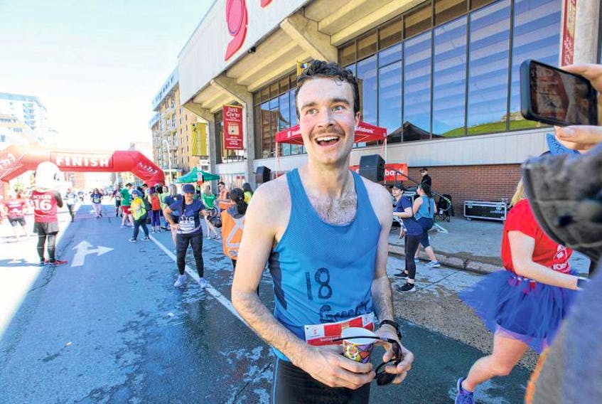 Cal Dewolfe of Conquerall Mills is all smiles after coming in first in the men’s full marathon at the Scotiabank Blue Nose Marathon on Sunday.