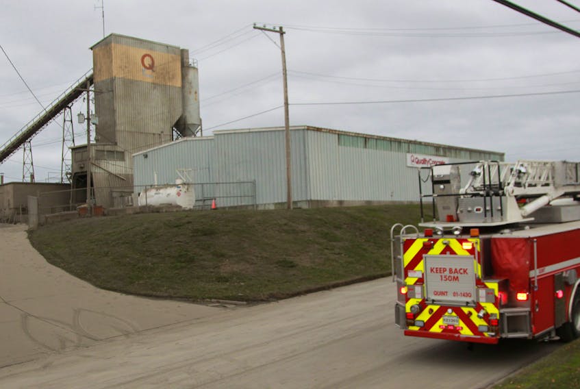 The large grey and yellow building at rear is the concrete truck loading facility, of which the fly ash silo is a part.