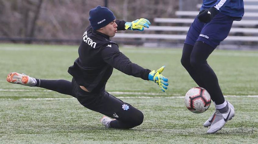 HFX Wanderers FC keeper Christian Oxner lunges for a stop on a teammate during a scrimmage at the conclusion of practice at the Mainland Common in Halifax on Thursday.