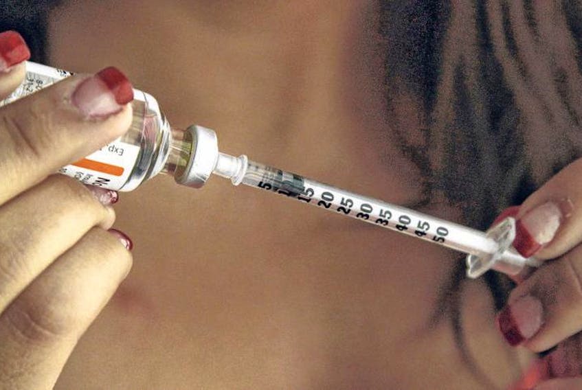 A diabetic patient fills a syringe as she prepares to give herself an injection of insulin. Diabetes Canada is lobbying government to support a comprehensive plan to tackle rising diabetes rates.