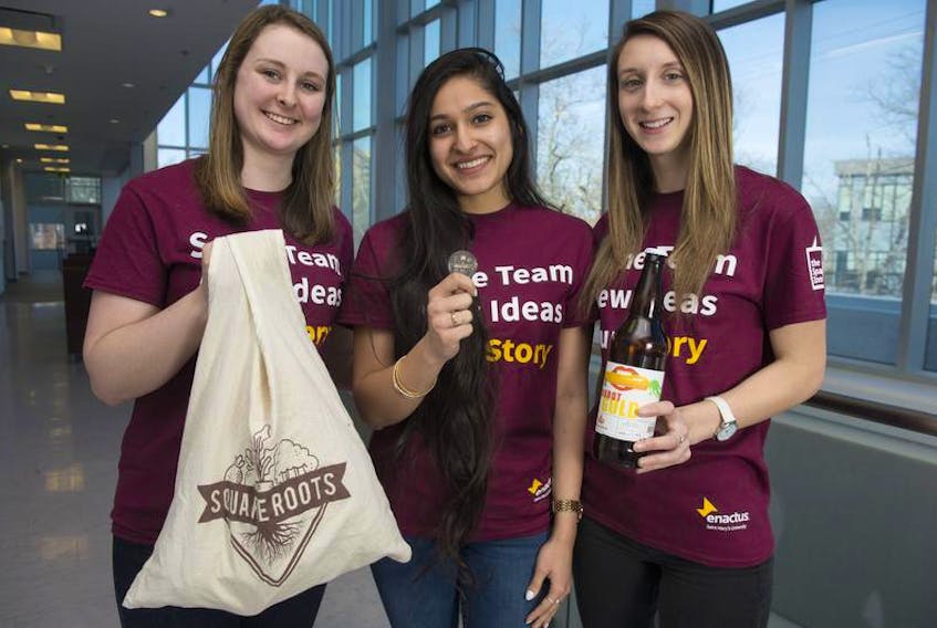 Saint Mary’s University students Becca Watts, Sehmat Suri and Sarah Little pose for a photo with some Square Roots items at the university on Thursday.