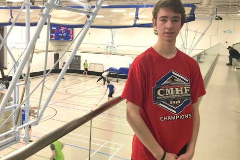 Daniel Henri of Port Williams stands in the balcony of the Wolfville School gym as a floorball game takes place below. Henri is one of four Nova Scotians on the under-19 Team Canada floorball team.