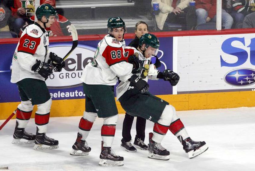 Halifax Mooseheads captain Antoine Morand and athletic therapist Robin Hunter carry defenceman Jared McIsaac off the ice after taking a check in a January 13 game at the Scotiabank Centre.