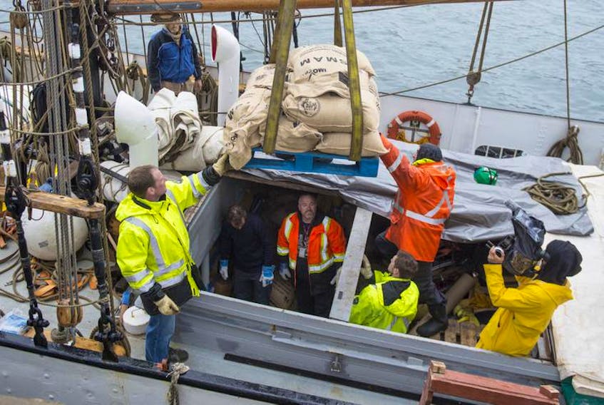 A pallet of sacks filled with coffee beans is hoisted from the cargo hold of Avontuur, a two-masted schooner docked in Halifax. The cargo for Just Us Coffee Cooperative in Grand Pré was unloaded Wednesday by members of the Halifax Longshoremen’s Association Local 269, who volunteered their time.