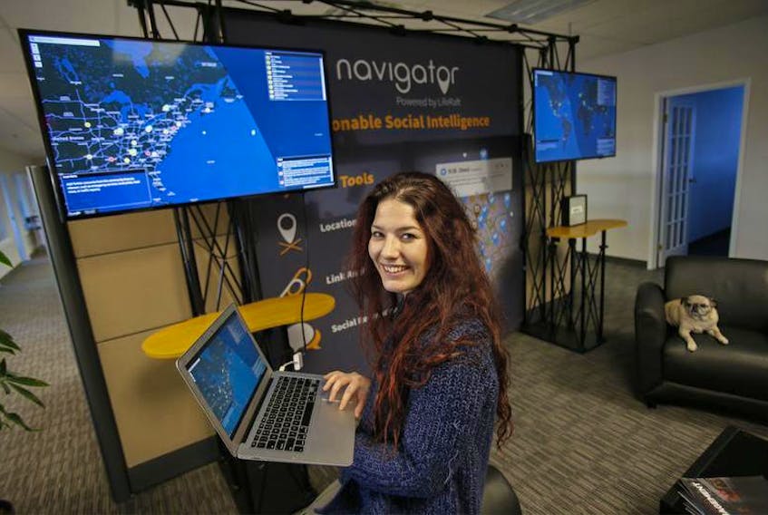Melissa Cooper, marketing and communications manager with LifeRaft Inc., is seen in the company’s Bayers Lake office in Halifax on Friday. The company uses AI to monitor threats to clients that occur on the internet.