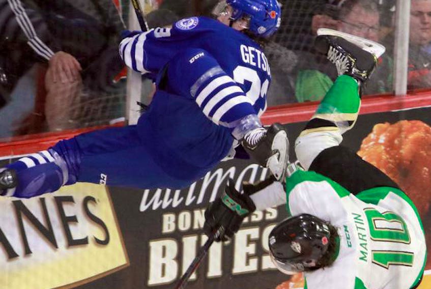 Halifax Mooseheads’ Keith Getson, left, and Prince Albert Raiders’ Max Martin go flying after a major collision behind the Halifax net in the first period of the opening game in the Memorial Cup on Friday at Scotiabank Centre.