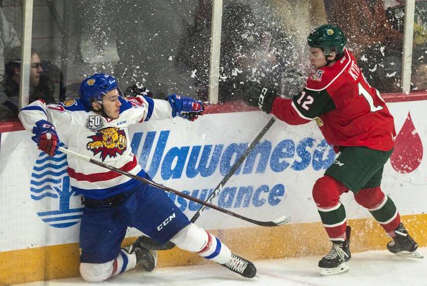 Moncton Wildcats forward Nicolas Kingsbury-Fournier and Halifax Mooseheads defenceman Patrick Kyte kick up some snow as they crash into the boards during the first period of Friday’s game at the Scotiabank Centre.