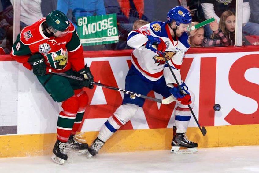 Moncton Wildcats winger Charles-Antoine Giguere and Halifax Mooseheads forward Brock McLeod crash into the boards as they chase the puck during Friday’s QMJHL playoff game at the Scotiabank Centre.