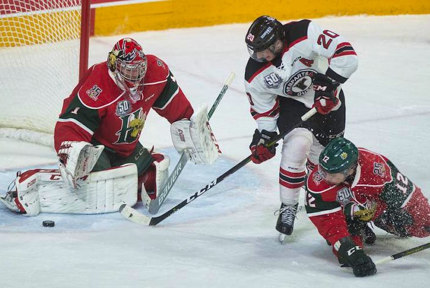 Quebec Remparts forward Andrew Coxhead shoots wide on Halifax Mooseheads goalie Alex Gravel as Mooseheads defenceman Patty Kyte looks on during the third period of Tuesday night’s QMJHL playoff Game 7 at the Scotiabank Centre. The Mooseheads won 3-1 to advance to the second round.