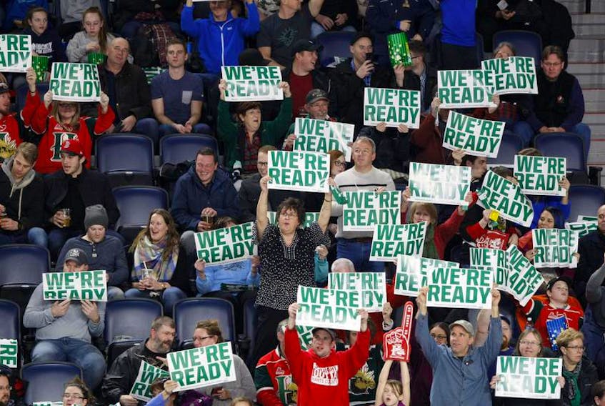 Halifax Mooseheads fans at a Feb. 24 game against the Gatineau Olympiques hold up signs at the Scotiabank Centre.