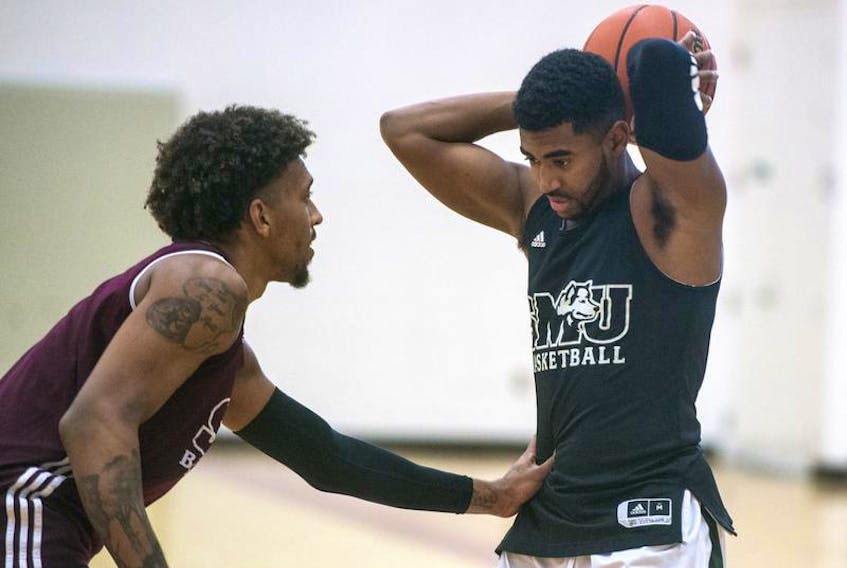 Nikita Kasongo, the 2018 U Sports men’s basketball rookie of the year, guards North Preston’s Nevell Provo during a Saint Mary’s Huskies team practice at the Homburg Centre.