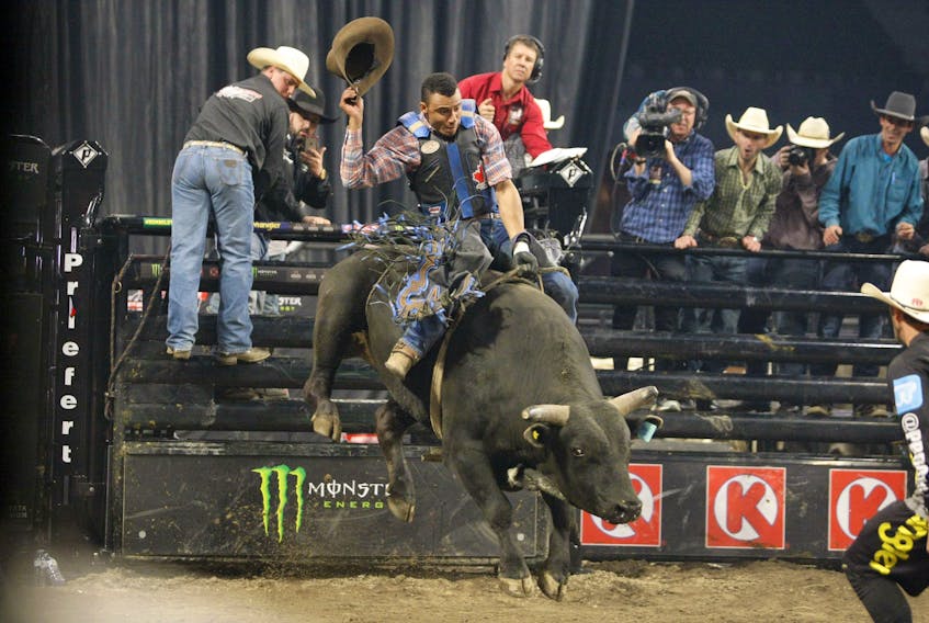 Marcos Gloria, of Central de Minas, Brazil, takes his hat off as he nears the successful requirement of staying on the bull for eight seconds during the second round of PBR competition at Scotiabank Centre in Halifax on May 26, 2018. He was riding Ulterra’s Night Vision.