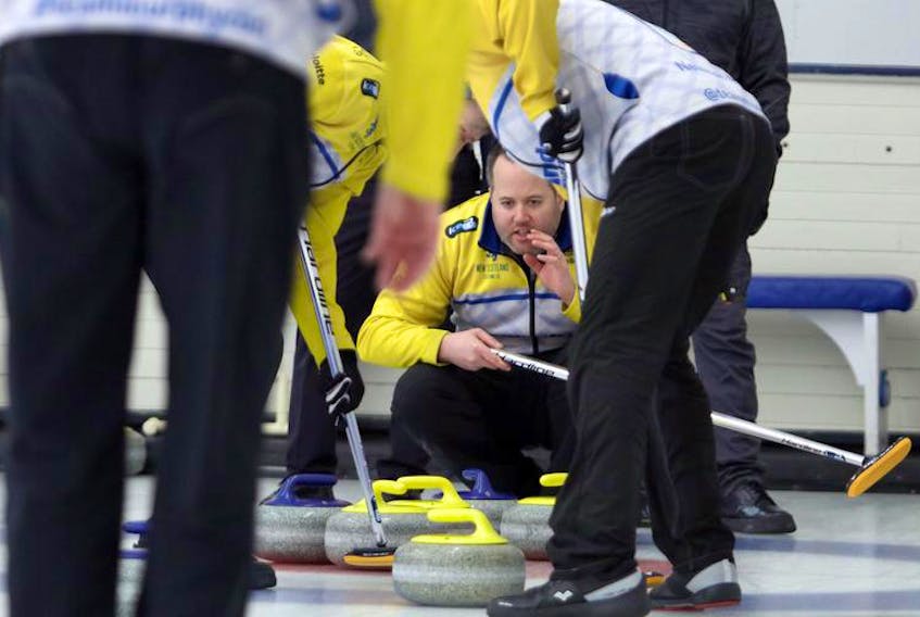 Skip Jamie Murphy directs his sweepers during the third end of their game against Doug MacKenzie at the Deloitte Tankard men’s provincial curling championship at the Dartmouth Curling Club on Tuesday.