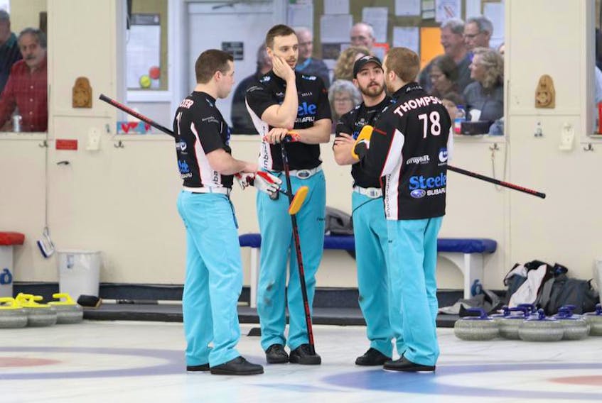 Skip Stuart Thompson, left, talks with teammates Travis Colter, Colten Steele and Taylor Ardiel during the final of the Nova Scotia men’s curling championship at the Dartmouth Curling Club on Jan. 27.