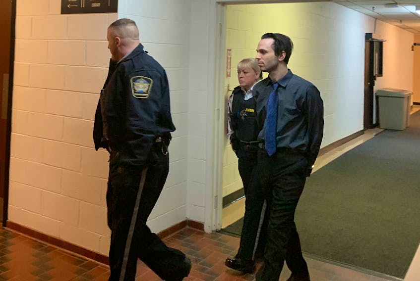Aaron Byron Cumberland is led from Kentville Supreme Court on Wednesday, May 15, 2019.