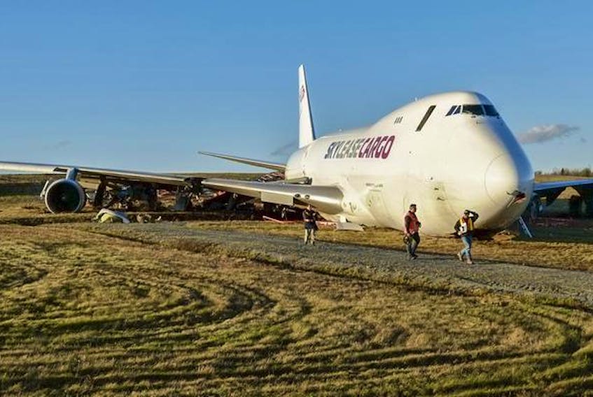 Investigators from the Transportation Safety Board are seen in front of a Skylease Cargo Boeing 747-400, which went off the end of Runway 14 as it was landing at Halifax Stanfield International Airport Wednesday.
