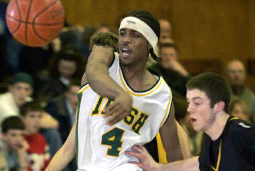 St. Patrick’s High School’s Christian Upshaw passes the ball against the defence from Horton High's Mike Metzger during a 2004 game.