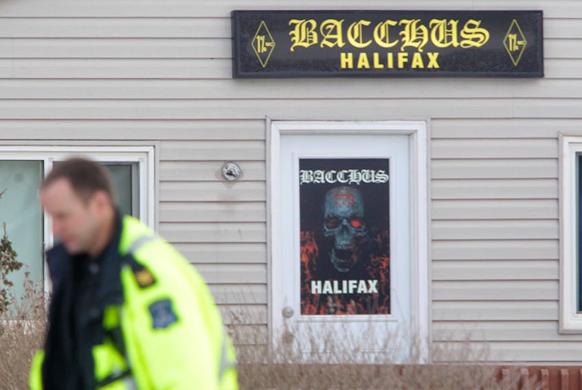 A Halifax Regional Police officer walks in front of the Bacchus Halifax motorcycle club on Sambro Road in 2015.
