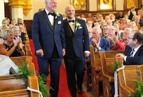 Cape Breton Regional Municipality Mayor Cecil Clarke, left, walks down the aisle with his partner Kyle Peterson at the St. Matthew Wesley United Church in North Sydney, during their wedding ceremony Saturday.