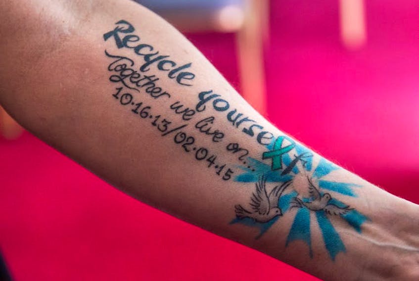 A Nova Scotia woman displays the tattoo that marks her two liver transplants at the provincial legislature in Halifax in April 2019. The province’s Human Organ and Tissue Donation Act will allow Nova Scotians to donate their organs and tissue unless they opt out.
