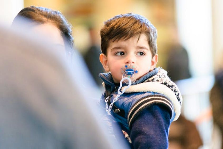 A young boy, part of a Syrian refugee family, arrives in Canada in February 2016.