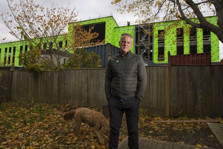 John DeMont poses for a photo in his backyard on Monday afternoon. With the construction from the new LeMarchant-St. Thomas School next door and the continual chatter about the U.S. election, John is finding it difficult to find a quiet space.