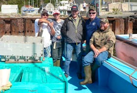 Aulds Cove fisherman Allan Anderson, shown with his son Blaine and grandson Mackenzie, says his belated friend Stevie MacInnis was known as one of the finest tuna fishermen in Atlantic Canada. From left, Blaine Anderson, Mackenzie Anderson, Allan Anderson, Stevie MacInnis and Marcel Forgeron. - Marcel Forgeron