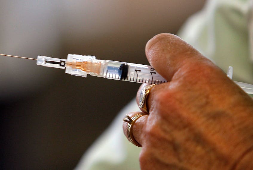 A nurse prepares a dose of flu vaccine at the Northwood Centre.