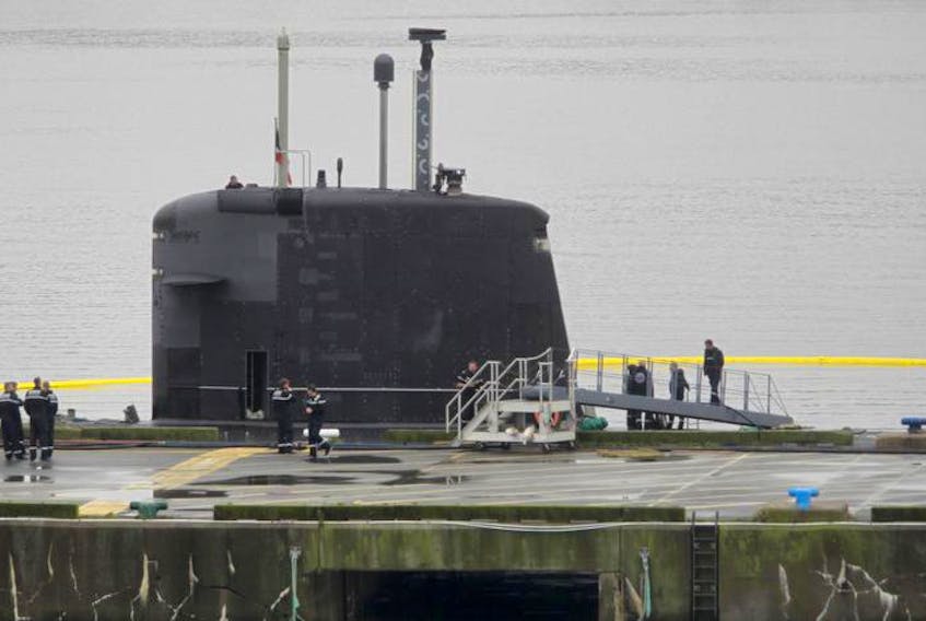 Crew members of the FS Amethyste S605 are seen in front of the sub as it sit’s at a jetty at CFB Shearwater on Friday.