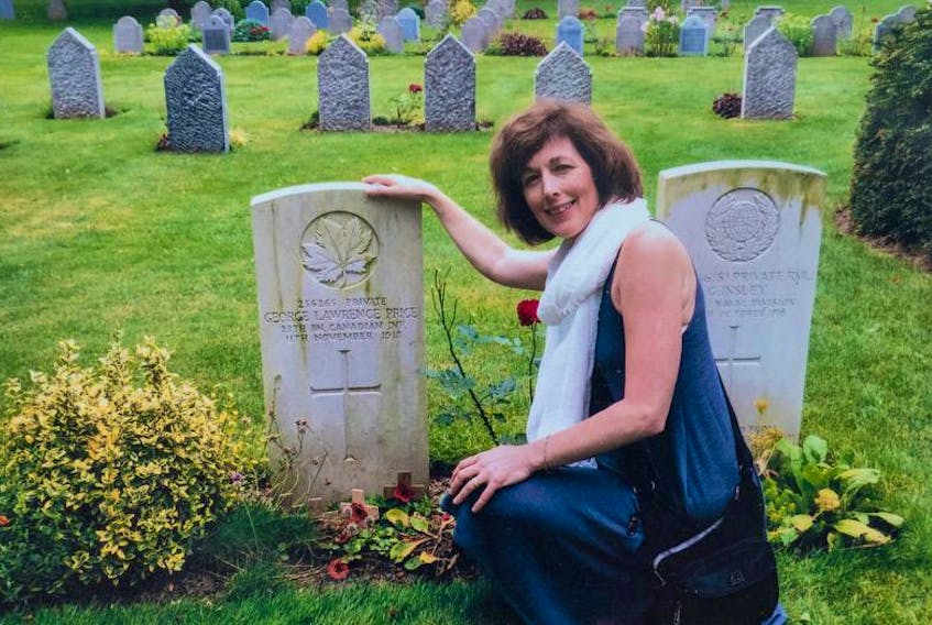 Rhonda McLean, grand niece of George Price at his grave site in St. Symphorien Military Cemetery near the hamlet of Ville-sur-Haine, Belgium.