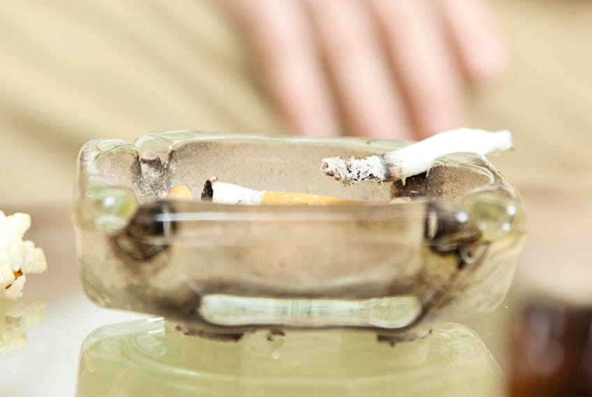A smoked joint (marijuana) sits in an ashtray.