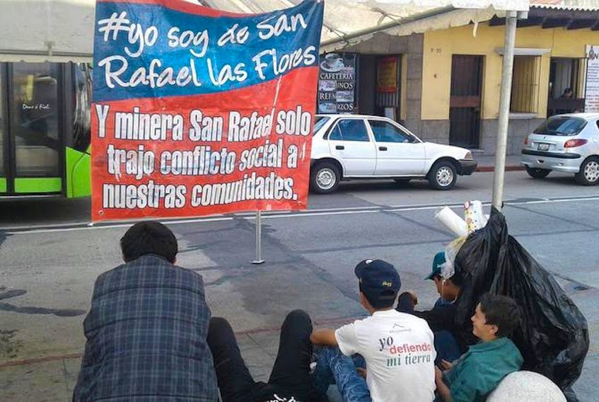 A sign reads: “I am from San Rafael Las Flores and the mine only brought social conflict to our communities.”