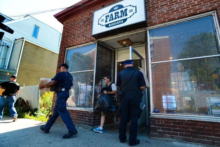 Police remove several items from Farm Assists on Gottingen Street in Halifax following a raid on the medical marijuana operation in September 2015.