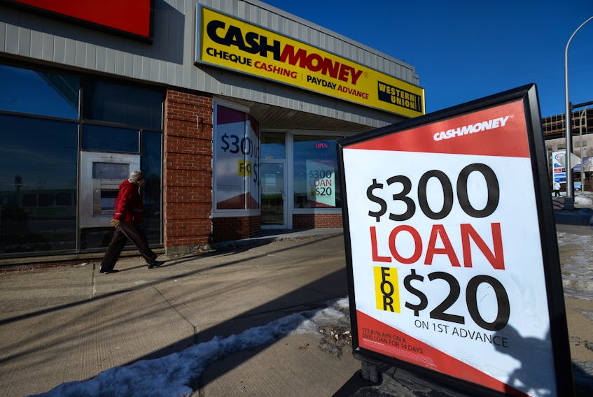 A pedestrian walks past a payday loan store on Chebucto Road in Halifax, N.S. on Jan. 6, 2015.