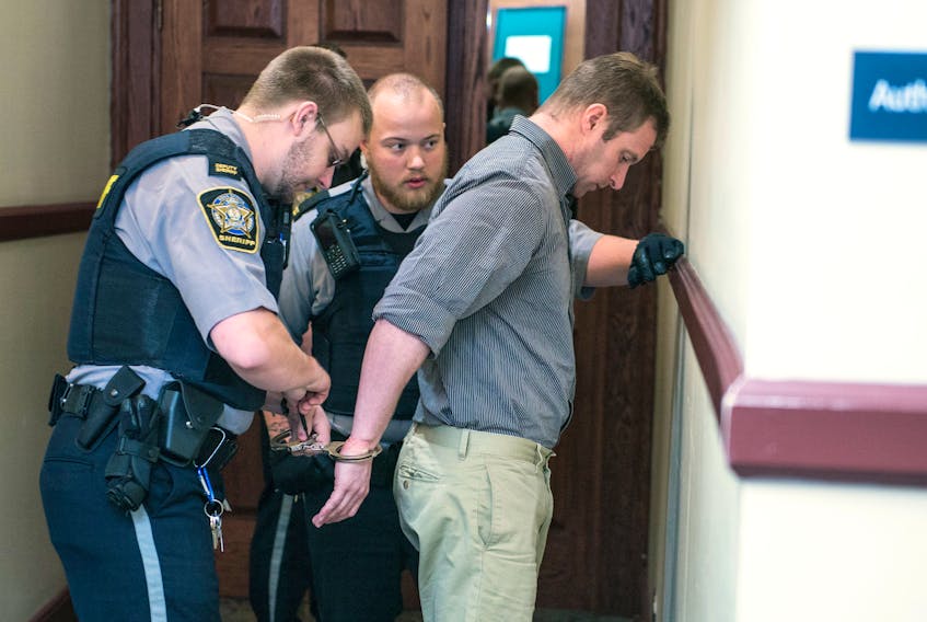 Matthew Albert Percy is escorted into Halifax provincial court Friday for closing arguments at his trial on charges of sexual assault and voyeurism.