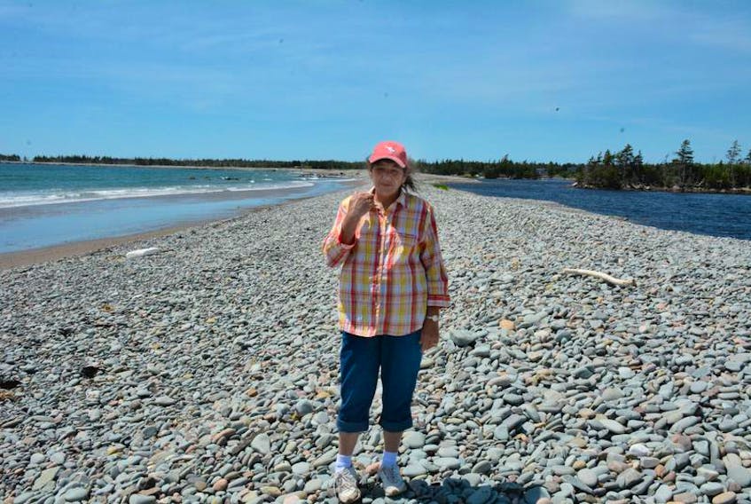 Resident Margie Wade of Lower East Chezzetcook stands on a berm that holds back the Atlantic Ocean from what locals call Big Lake. The berm was compromised in a storm last winter and residents want it repaired.