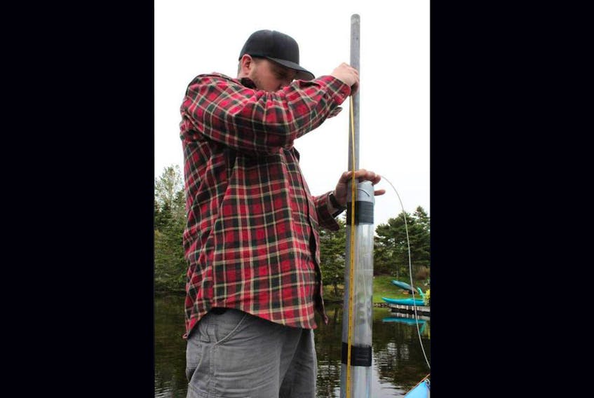 Bishop’s University student Frank Oliva handles a sediment core while assisting the research project conducted by Matthew Peros in Nova Scotia.