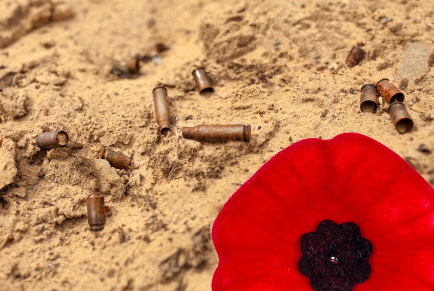 Spent rusty shells and a poppy for Remembrance Day.