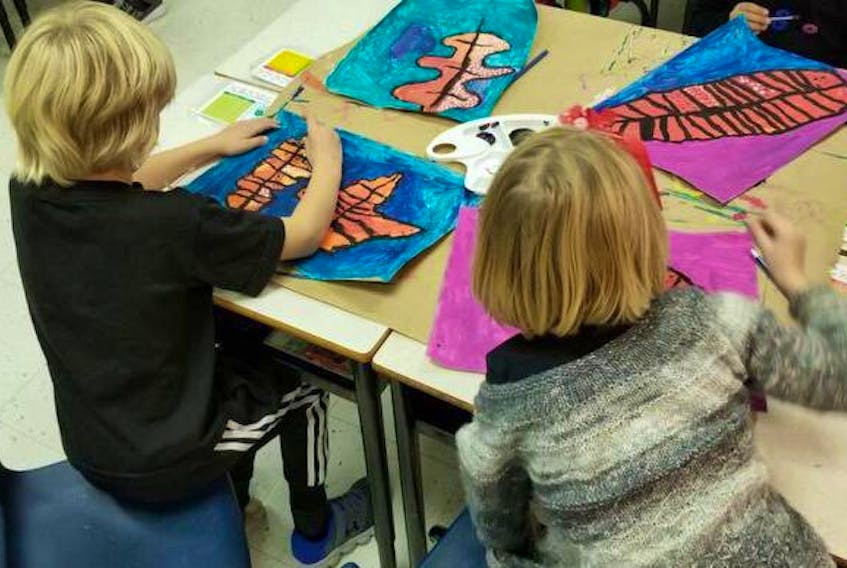 Children at St Thomas school in Halifax work on art during a class in October.