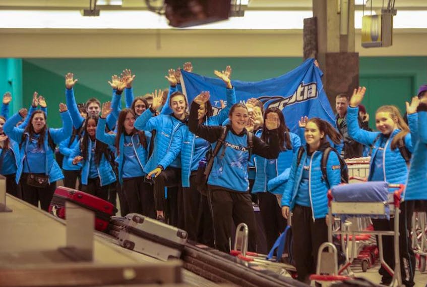 Team Nova Scotia athletes wait for their luggage at the Calgary International Airport on Thursday. The athletes were then taken by bus to Red Deer, the host of the Canada Winter Games that begin on Friday with the opening ceremony. Competition begins on Saturday.