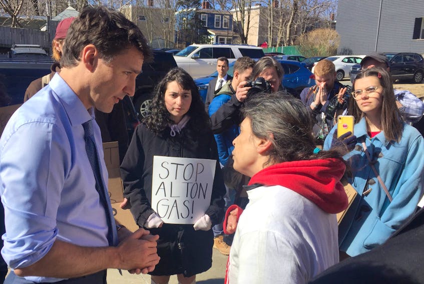 Darlene Gilbert confronts Prime Minister Justin Trudeau as protesters look on outside Northwood Residences in Halifax on Thursday.
